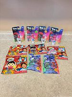 Full lot: 3 Trolls blister cards, 5 Ryan's World card packs, 2 PJ Masks blind bags (10 items)