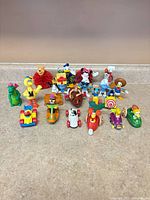 Group shot of all 20 toys – figures at back, vehicles front