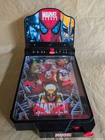Front view of Marvel tabletop pinball game showing playfield and score display