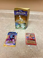 Starter deck box, booster pack and Mickey Mouse promo card displayed on countertop
