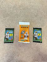 Front view of all three sealed Panini football card packs