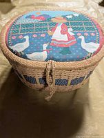 Closed oval wicker sewing basket showing top design