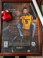 Framed Sidney Crosby poster with coin bank and rolled poster visible