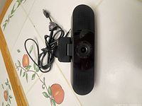 Front view of black 1080p webcam with cable and clip mount
