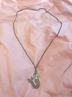 Full view of necklace with mermaid pendant on chain