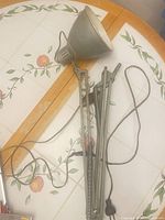 Full view of aluminum articulating lamp showing shade, double arm, springs and cord