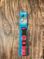 Front view of packaged Aspenpet red nylon adjustable collar
