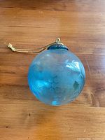 Full view of blue etched grape cluster ornament with hanger