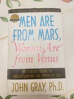 Front cover showing title, author, anniversary badge