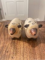 Front view of both sheep-shaped shakers