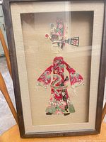Full view of framed textile artwork showing entire Chinese opera figure and wood frame