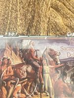 Front detail showing printed artwork and text "The Sacagawea Dollar"