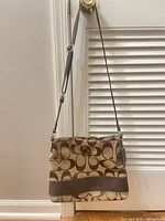Front view of Coach shoulder bag hanging