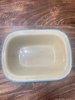 Top view of cream enamel pan showing interior and blue rim