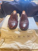 front view of shoes on box with dust bag