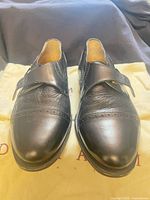 Top view of both shoes showing uppers, buckle, toe style