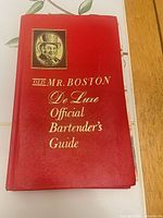 Front cover showing title, author image, and red boards