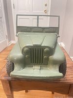 Front view showing grille, hood, windshield and wheels