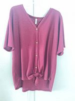 Front view of burgundy waffle knit top on hanger