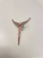 Front view showing patriotic enamel design and overall shape