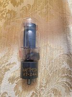 Front view showing Raytheon branding, VT-244 model on base, full glass envelope and pin configuration