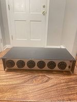 Front view showing six control knobs and indicator