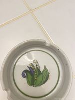 Top view of ashtray showing floral motif and three rests