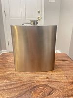 Front view of stainless steel hip flask with screw cap