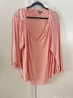 Front view of pink coral XXL blouse hanging