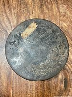 Top view showing peacock motif, label residue, surface wear