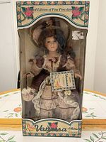 Front view of boxed porcelain doll