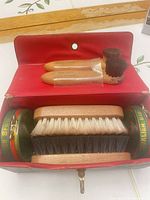 Open case showing brushes, polish tins and interior