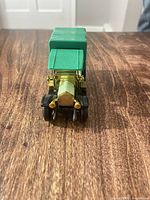 Front view showing gold radiator, lamps and green roof