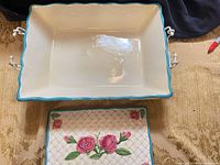 Top view of casserole interior, rim color, stand handles visible, trivet pattern and motif shown