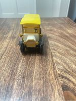 Front view of yellow-roof ambulance toy showing grille, hood, wheels