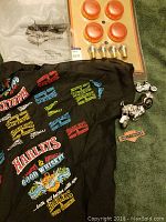 Overview photo showing black cloth item with colorful Harley Davidson prints, miniature motorcycle figurines, and Harley Davidson accessories card.