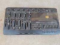 Front view of Yamaha MT100 II audio mixer showing control knobs, sliders, and branding with dust on surface.