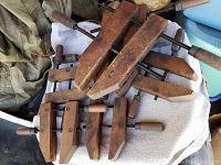 Top view showing six wooden bar clamps stacked on a towel, displaying the wooden parts and handles.