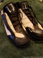 Front and top view of the black and white Nike Air Zoom Superbad shoes showing the lacing, Nike swoosh on tongue, and padded tongue.