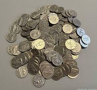 Pile of approximately 125 Canadian 5-cent coins spread out