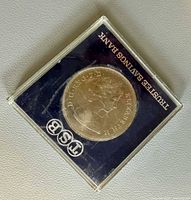 Obverse side of coin through case showing Queen Elizabeth II portrait and Trustee Savings Bank logo