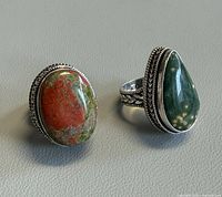 Front view of both silver plated rings displaying stones and bezels