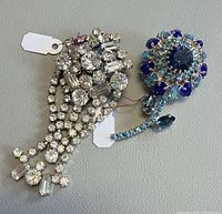 Both brooches side by side showing overall designs