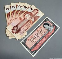 Set of six $2 notes, five 1986 notes overlapped and one 1954 note separated
