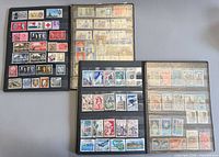 Open view of both albums showing mounted worldwide stamps