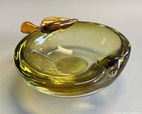 Top view showing apple shape, amber/yellow coloration and applied stem