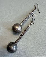 Front view of both sterling silver drop earrings showing full length and design details