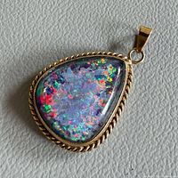 Front view of pendant showing opal and gold rope bezel