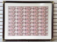 Framed uncut sheet on wall showing full view