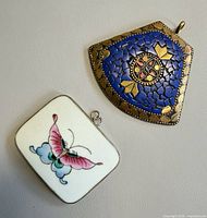 Front view of both pendants showing designs